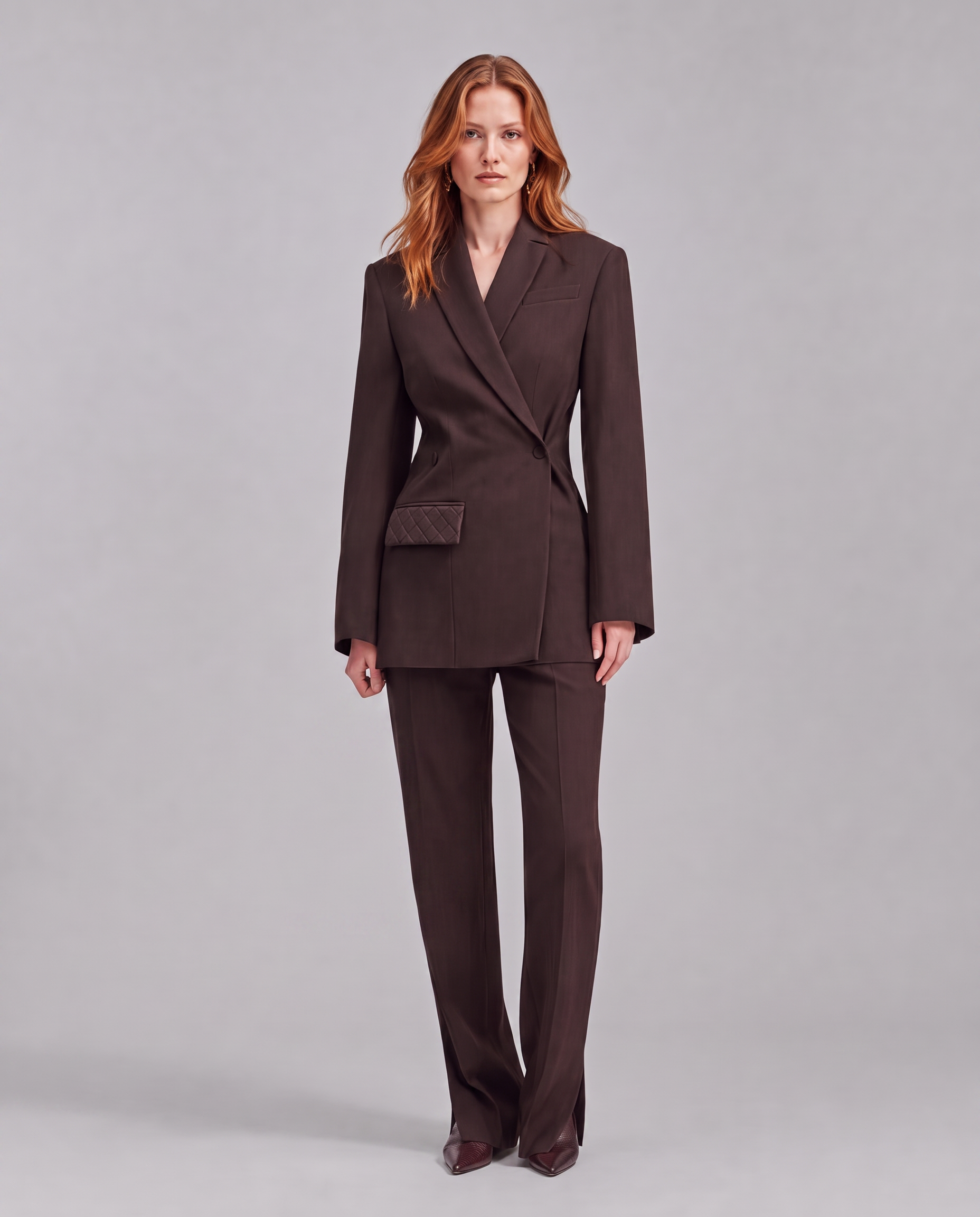 Chocolate brown blazer with an asymmetrical button closure.
