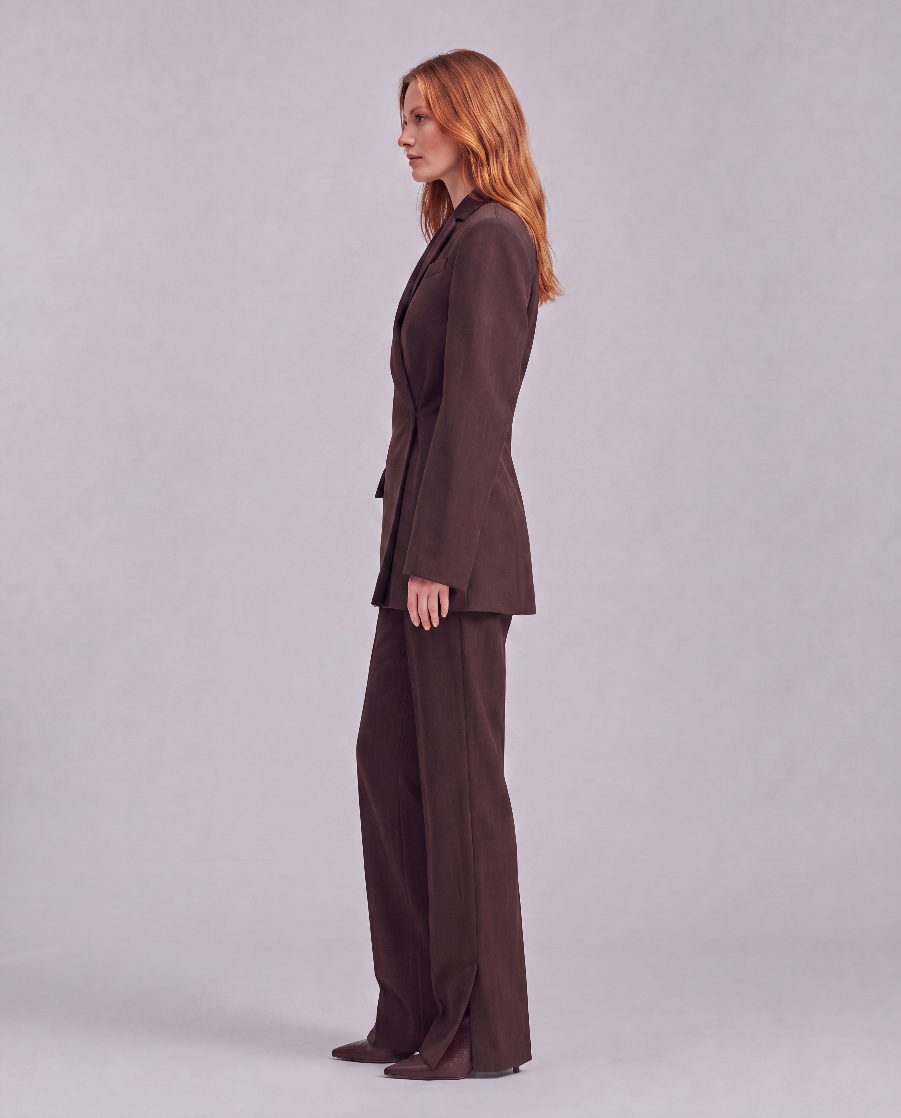 Chocolate brown blazer with an asymmetrical button closure.