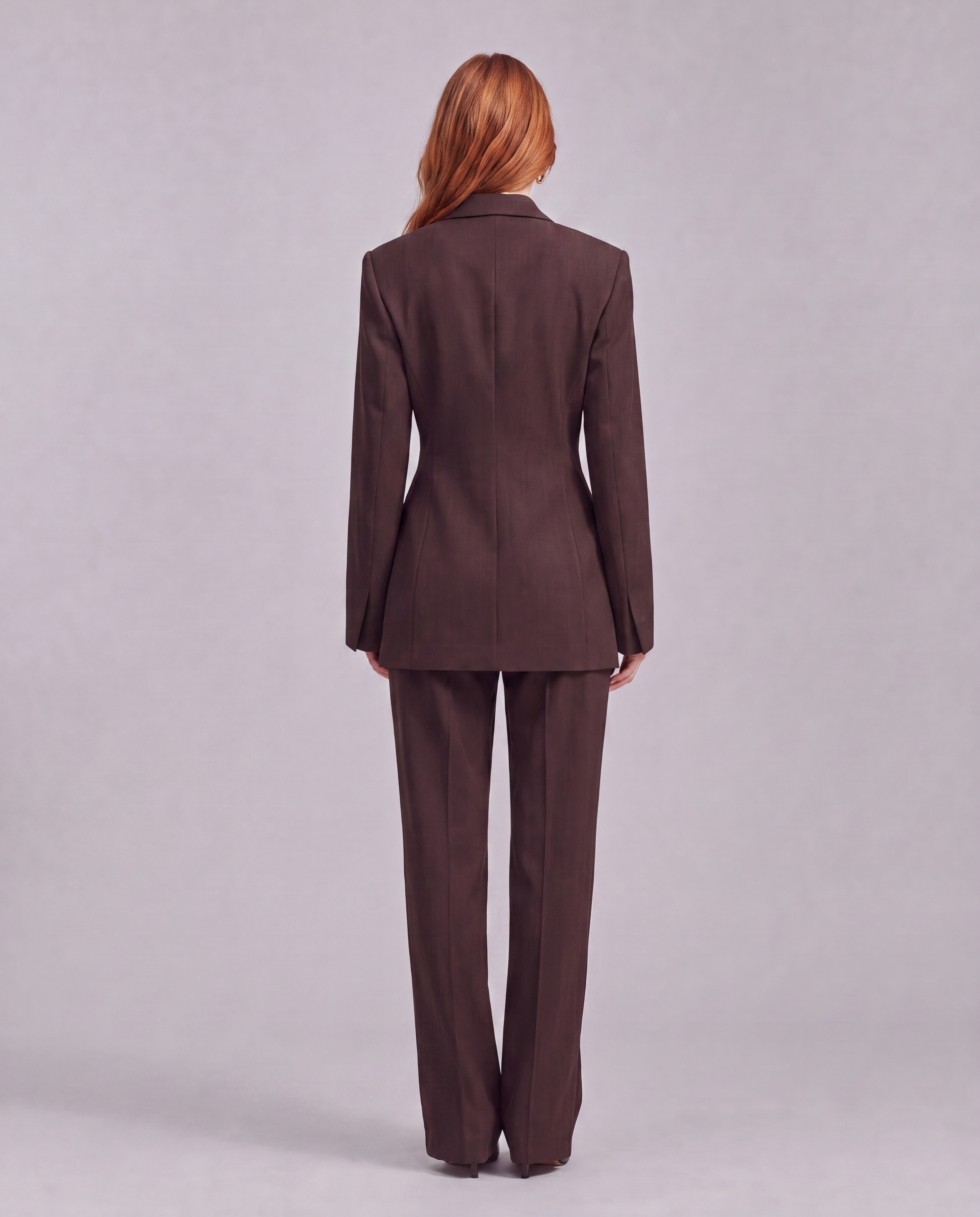 Chocolate brown blazer with an asymmetrical button closure.